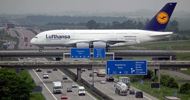 The pilot of this plane isn’t drunk rather the plane is landing Liepzig airport as it crosses over the Autobahn
